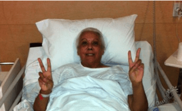 Jannette A Stewart smiles from her hospital bed
